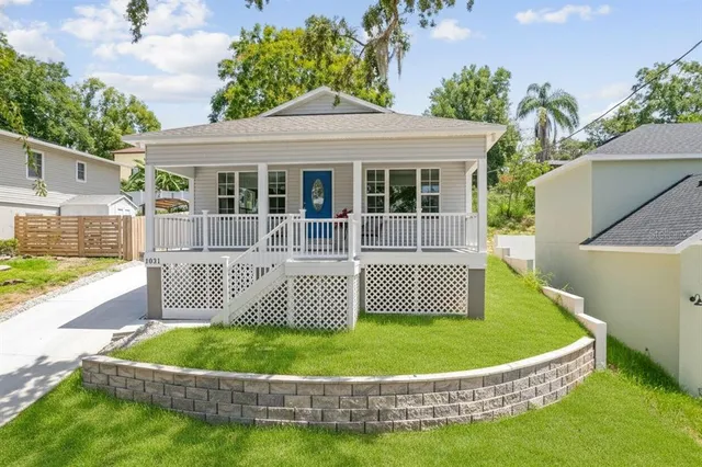 a view of a house with a small yard and plants