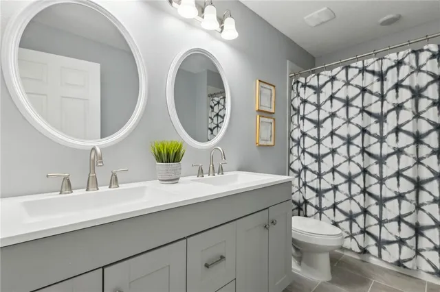 a bathroom with a sink mirror vanity and toilet