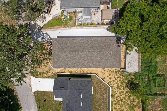 an aerial view of a house with a yard