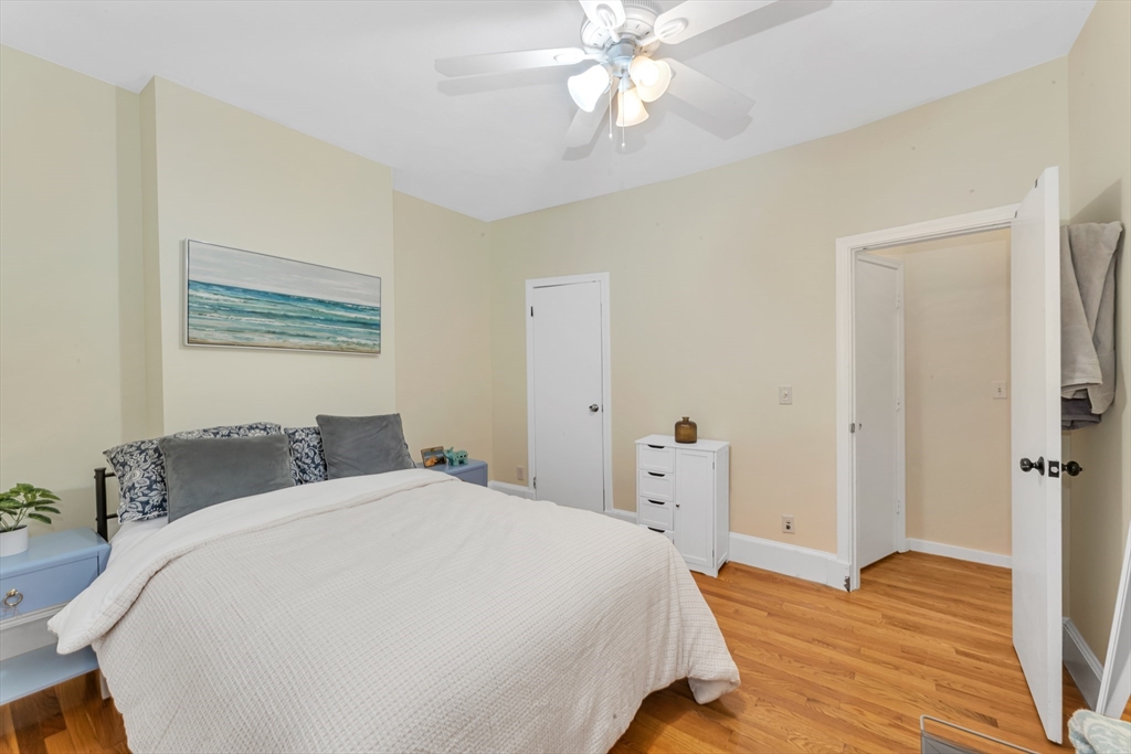 122 Day Street, Unit 3 Boston, MA 02130 - Photo 13 of 14 a bedroom with a bed and a chandelier