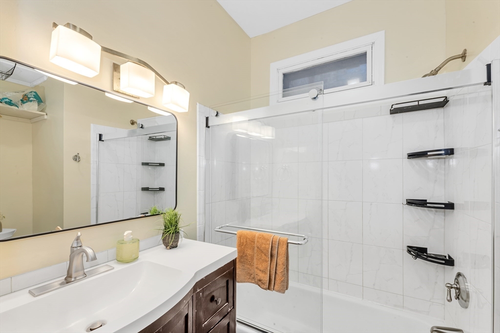 122 Day Street, Unit 3 Boston, MA 02130 - Photo 9 of 14 a bathroom with a sink and a mirror