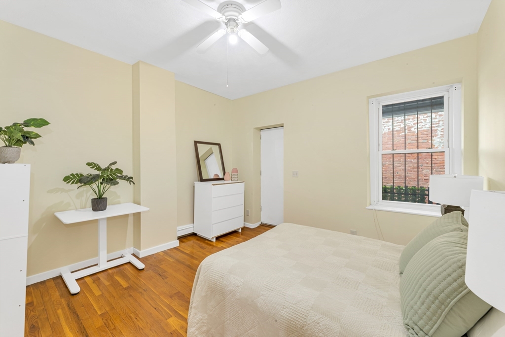 122 Day Street, Unit 3 Boston, MA 02130 - Photo 10 of 14 a bedroom with a bed and a potted plant