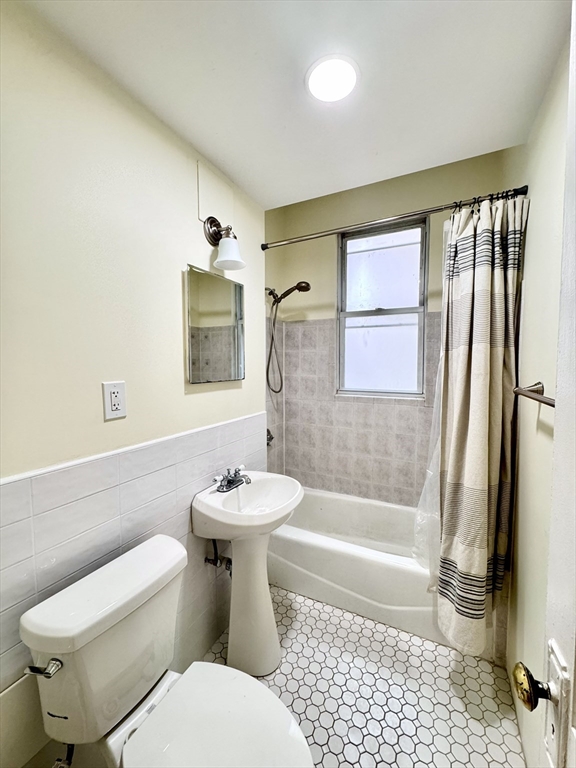 28 Sidlaw Road, Unit 2 Boston, MA 02135 - Photo 7 of 8 a bathroom with a toilet a sink and bathtub