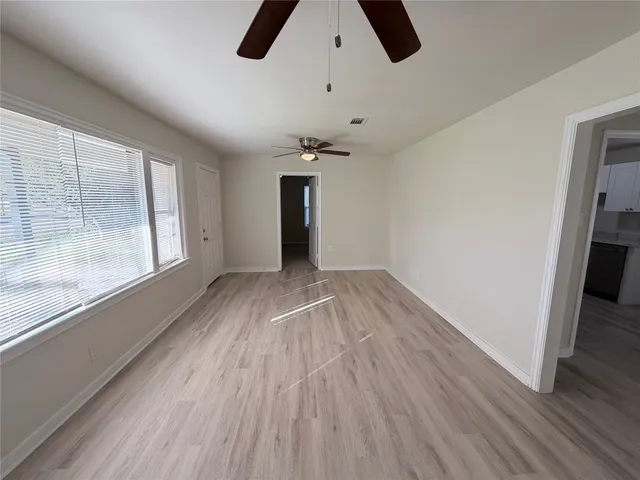 wooden floor in an empty room with a window