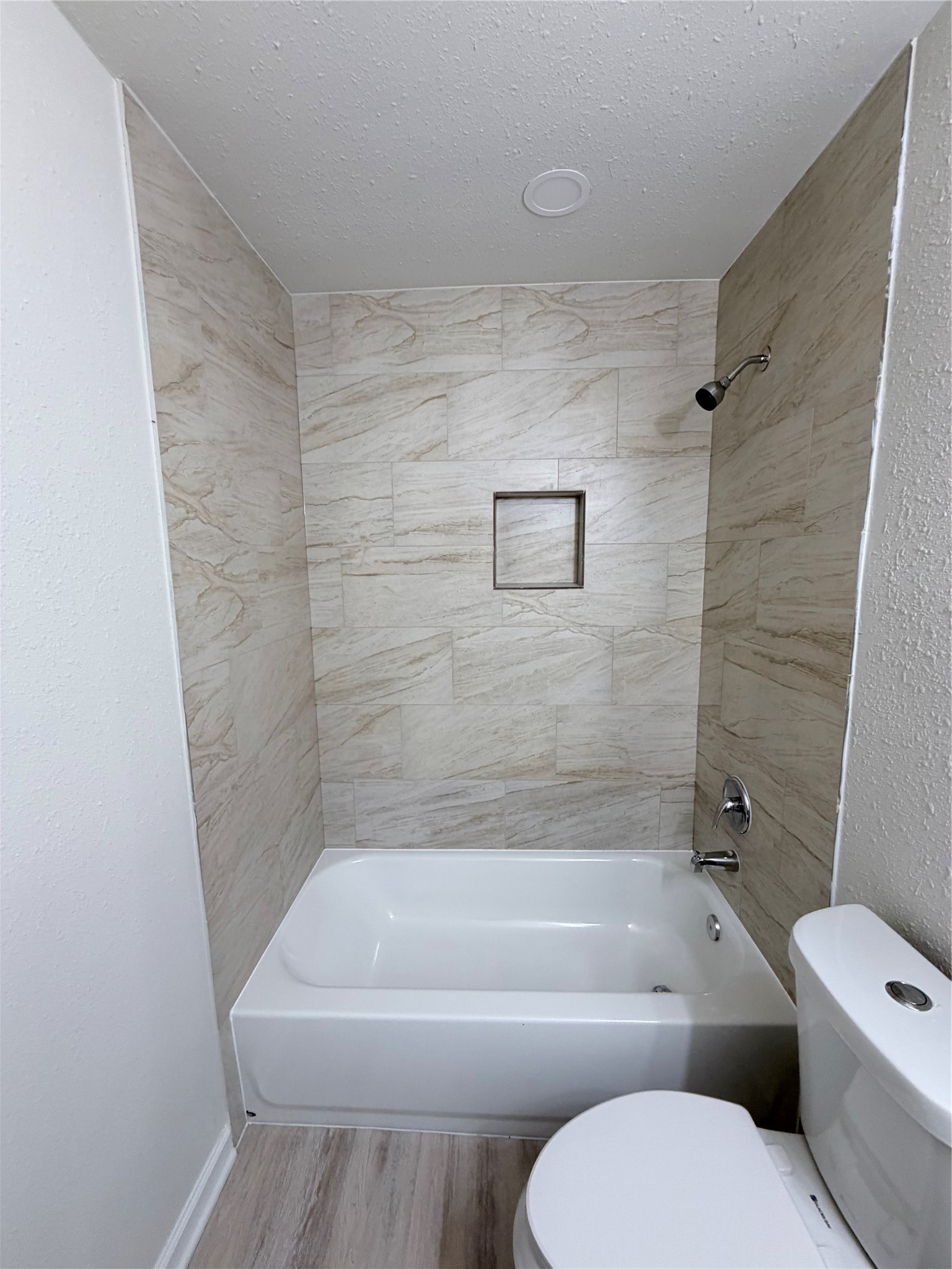 1003 Linden Street La Marque, TX 77568 - Photo 18 of 19 a bathroom with a toilet and a bath tub