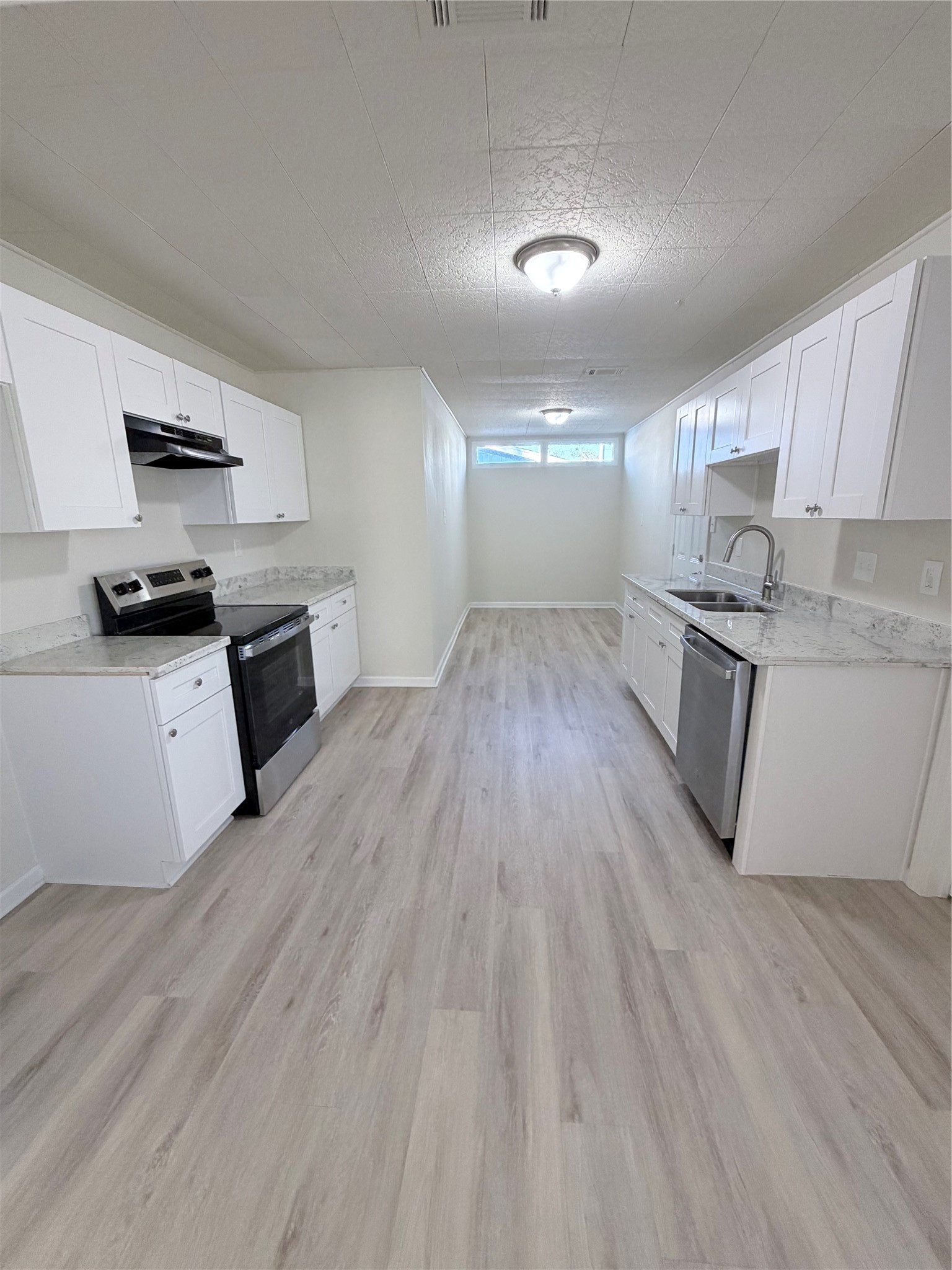 1003 Linden Street La Marque, TX 77568 - Photo 6 of 19 a kitchen with granite countertop a stove top oven and cabinets