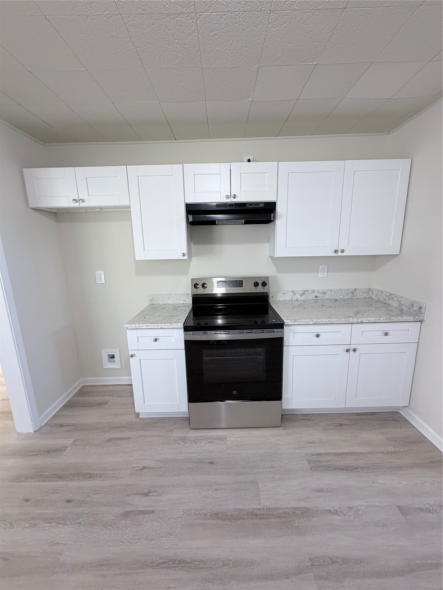 1003 Linden Street La Marque, TX 77568 - Photo 8 of 19 a kitchen with granite countertop white cabinets and black appliances