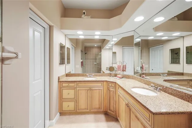 a large bathroom with a granite countertop sink and a mirror