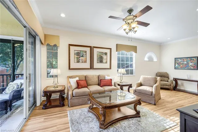 a living room with furniture a table and a large window