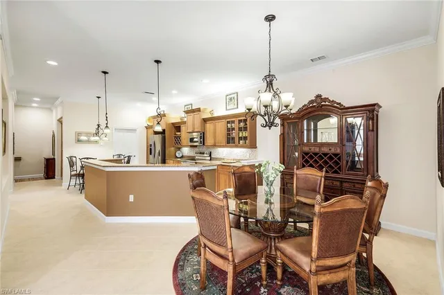 a view of a dining room with furniture and chandelier