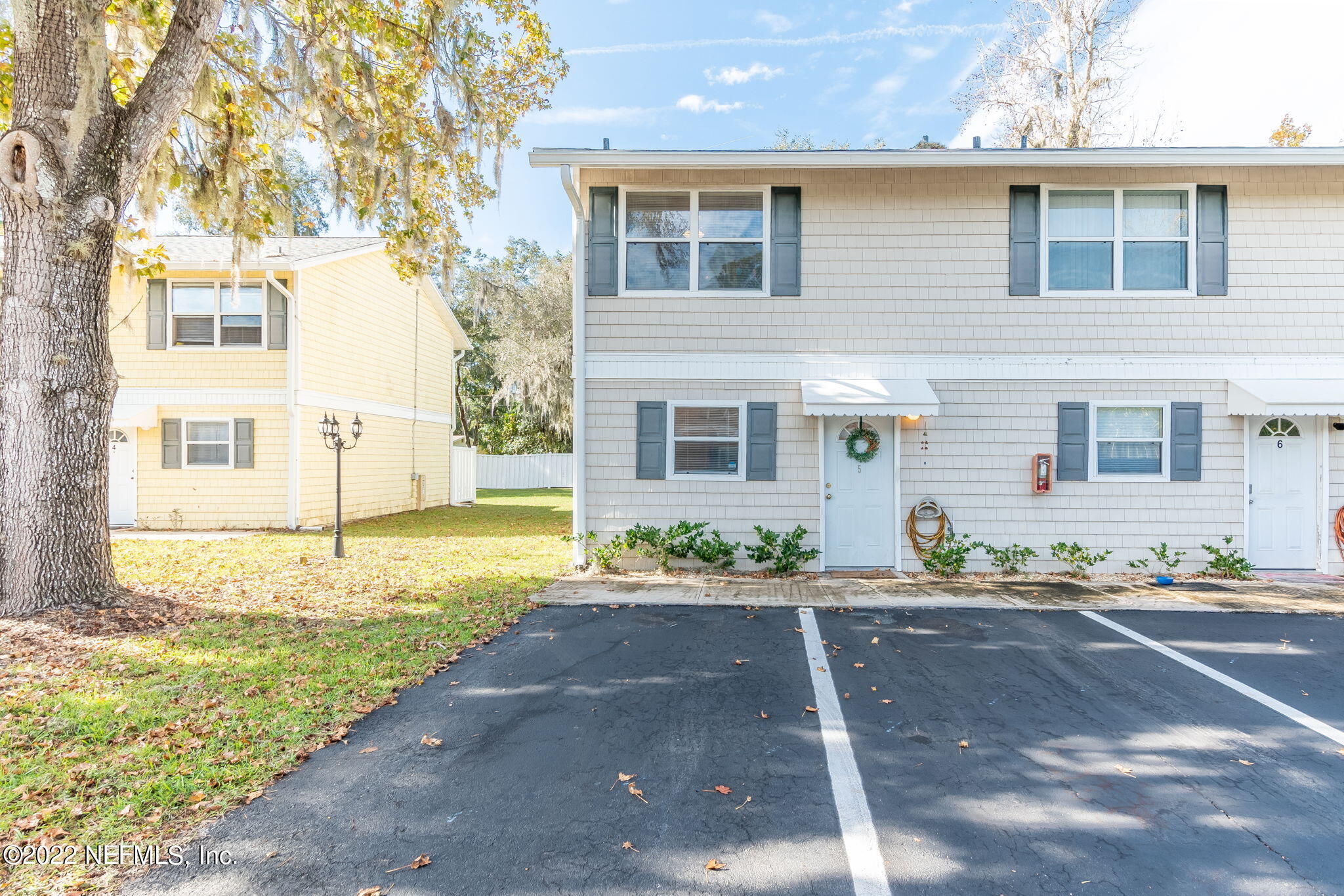 4420 Carter Road, Unit 5 St. Augustine, FL 32086 - Photo 1 of 29 a front view of a house with a yard and garage