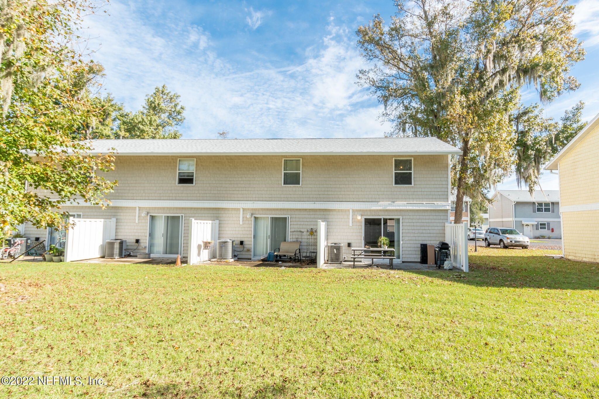 4420 Carter Road, Unit 5 St. Augustine, FL 32086 - Photo 25 of 29 a front view of house with yard and trees around