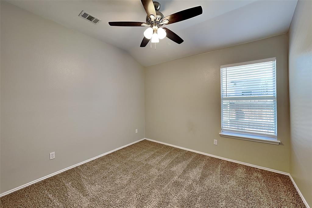 7016 Raintree Way Denton, TX 76210 - Photo 14 of 18 an empty room with a window and a fan