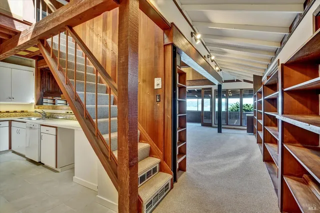 a view of an empty room with stairs