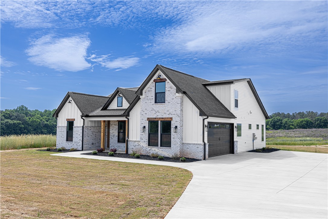 1619 Old Dobbins Bridge Road Townville, SC 29689 - Photo 2 of 34 This newly constructed home boasts a charming blend of brick and siding, featuring a spacious driveway.