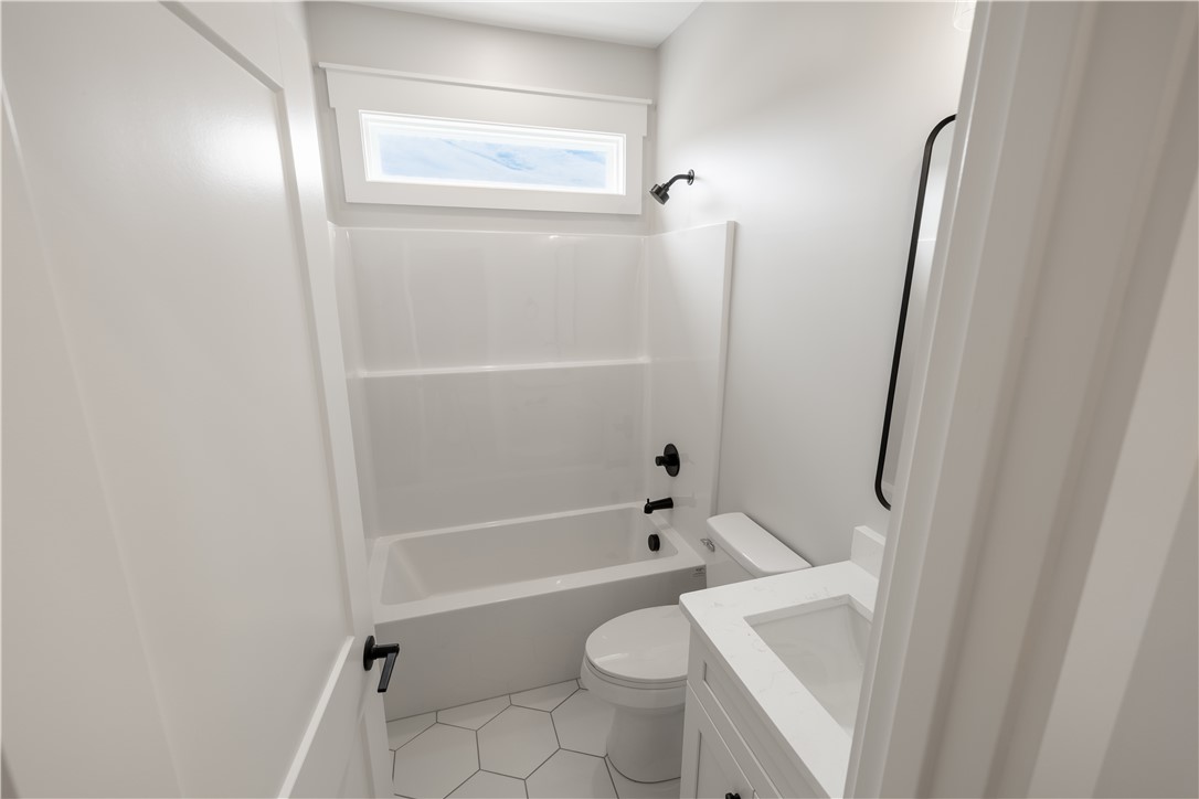 1619 Old Dobbins Bridge Road Townville, SC 29689 - Photo 22 of 34 This bright bathroom features a combined shower and bathtub, along with a modern vanity and clean finishes.