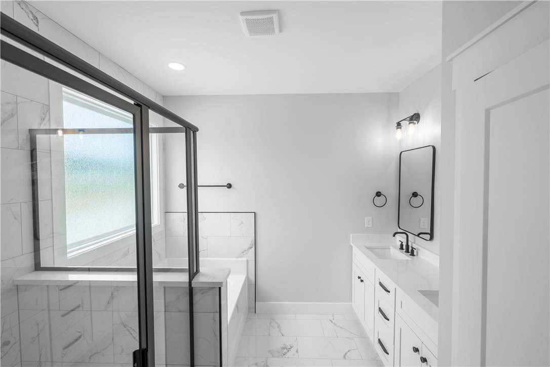 1619 Old Dobbins Bridge Road Townville, SC 29689 - Photo 25 of 34 This bright bathroom features a modern vanity, spacious shower, and elegant tile work throughout.