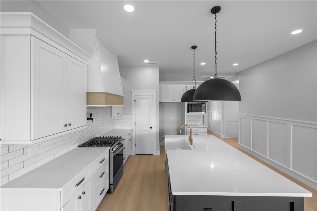 1619 Old Dobbins Bridge Road Townville, SC 29689 - Photo 28 of 34 This kitchen showcases a clean aesthetic with light wood flooring and contemporary fixtures.