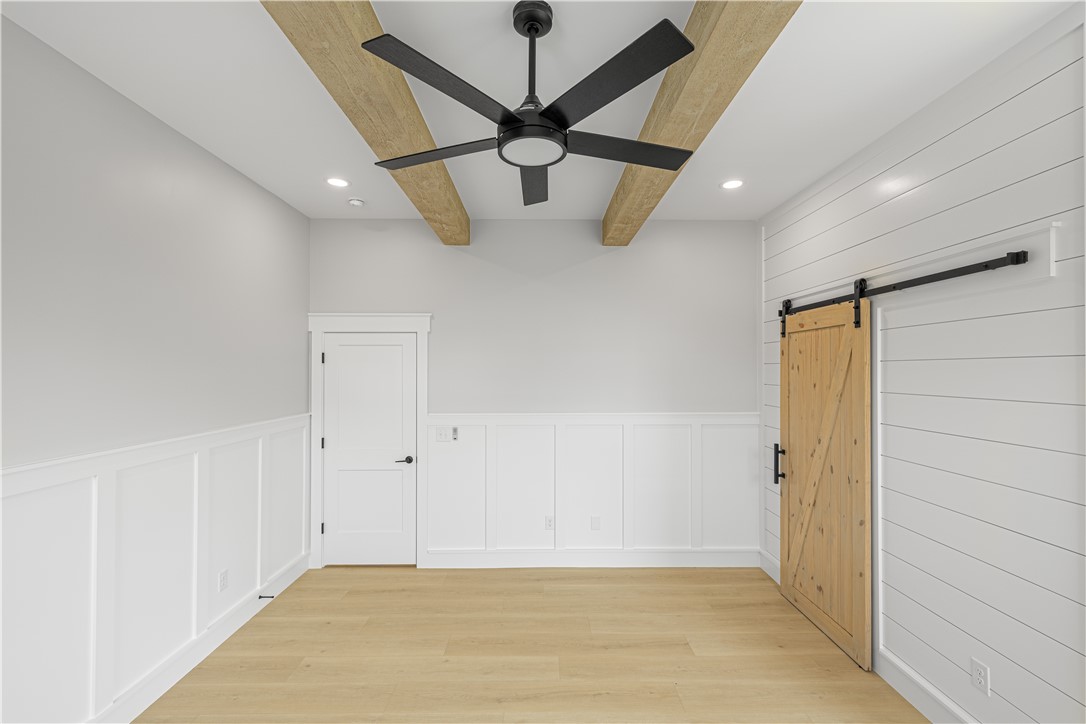 1619 Old Dobbins Bridge Road Townville, SC 29689 - Photo 29 of 34 This bright room features a beautiful wooden barn door and elegant ceiling beams.