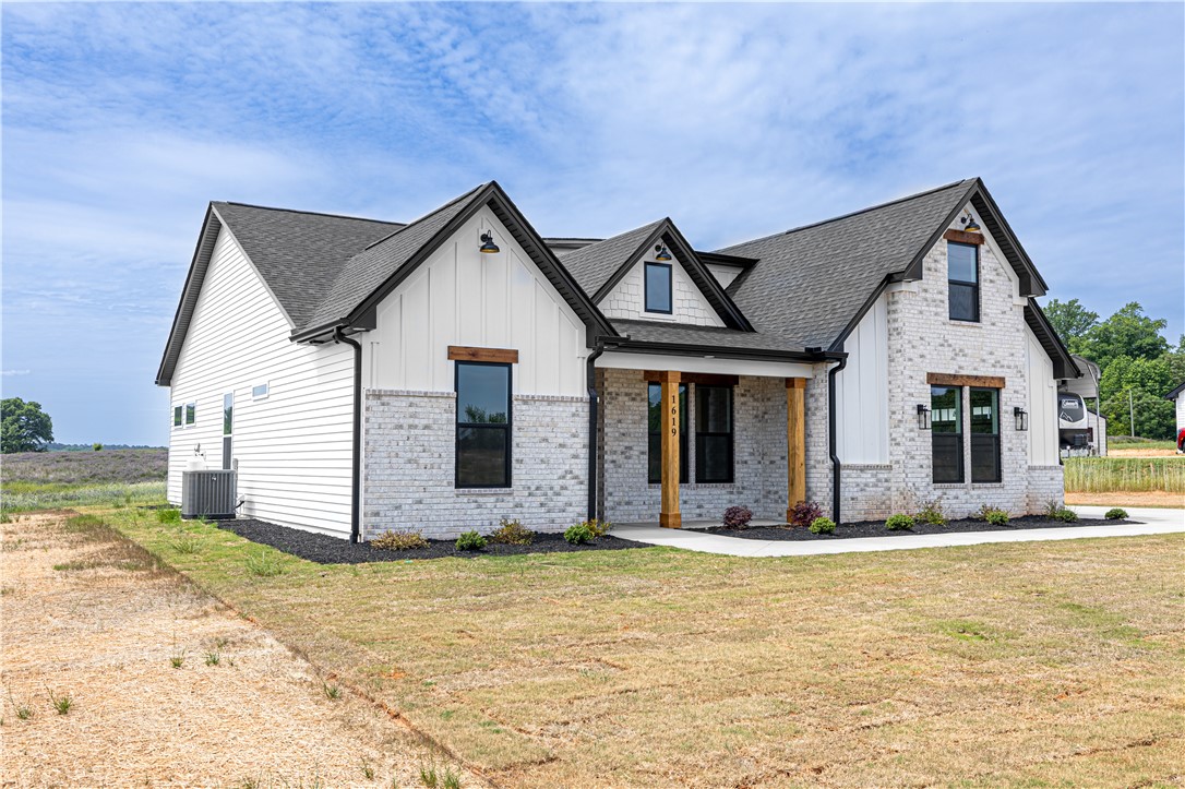 1619 Old Dobbins Bridge Road Townville, SC 29689 - Photo 3 of 34 This newly constructed home presents a striking blend of classic and modern architectural details.