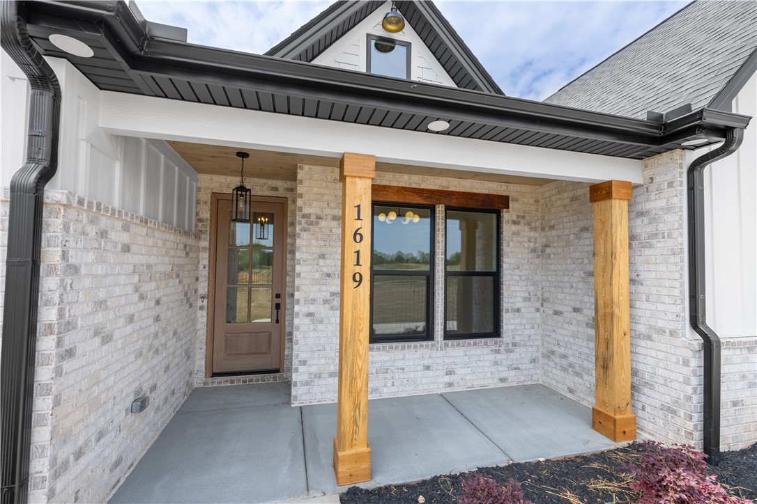 1619 Old Dobbins Bridge Road Townville, SC 29689 - Photo 4 of 34 This inviting home features a covered entrance with classic brick construction and welcoming architectural details.