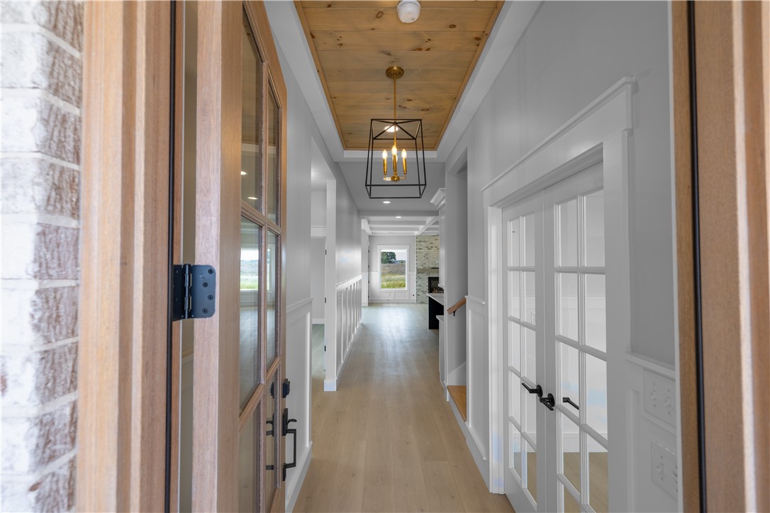 1619 Old Dobbins Bridge Road Townville, SC 29689 - Photo 6 of 34 Step into this luminous hallway, where natural light accentuates the wooden ceiling and plank flooring.
