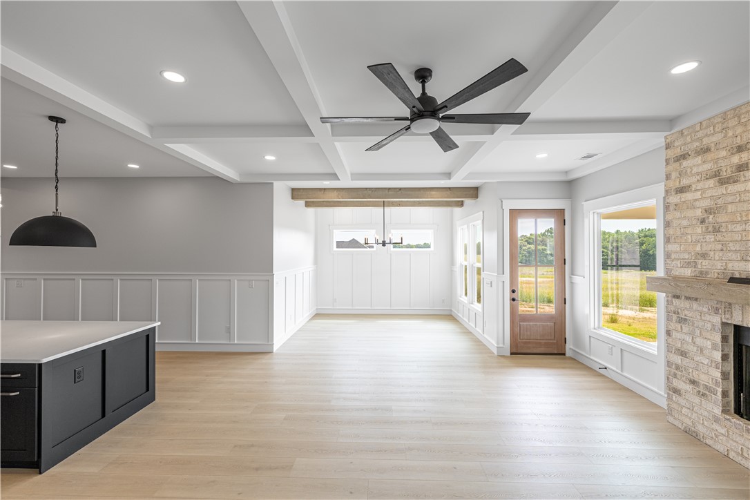 1619 Old Dobbins Bridge Road Townville, SC 29689 - Photo 9 of 34 This bright, open-concept living space boasts coffered ceilings, wood flooring, and large windows with outdoor views.