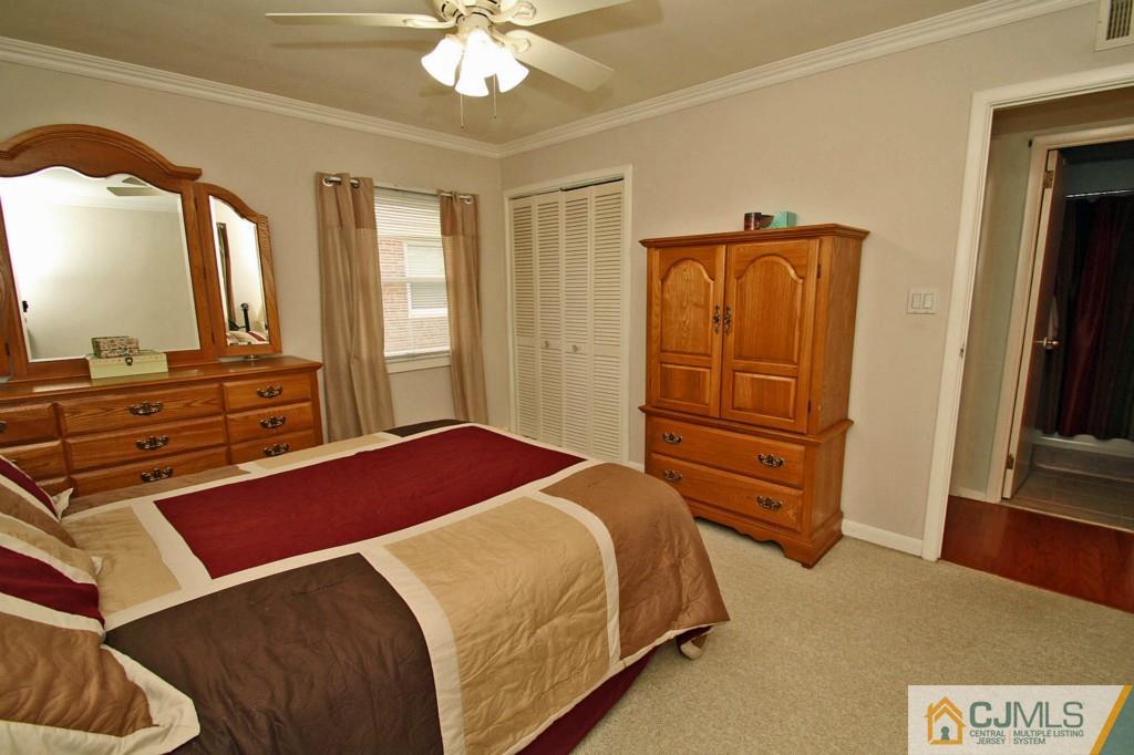 16 Roger Road Edison, NJ 08817 - Photo 14 of 18 a bedroom with a bed and a mirror on dresser