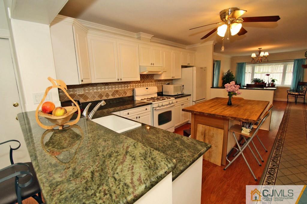 16 Roger Road Edison, NJ 08817 - Photo 8 of 18 a kitchen with a sink a stove and a table