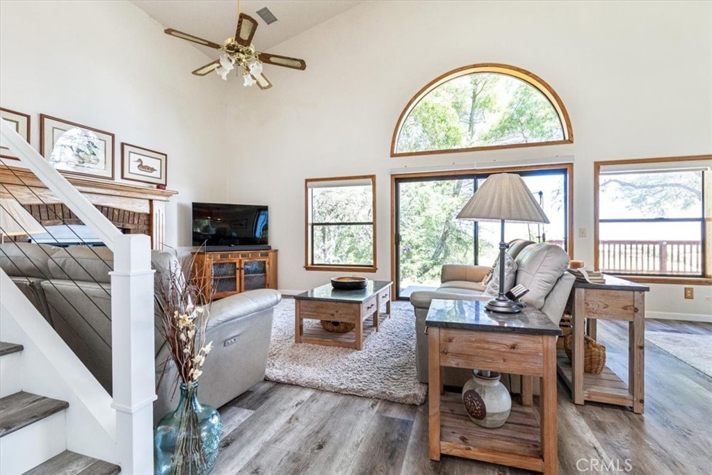 12355 Santa Ana Road Atascadero, CA 93422 - Photo 11 of 57 a living room with furniture a flat screen tv and a floor to ceiling window