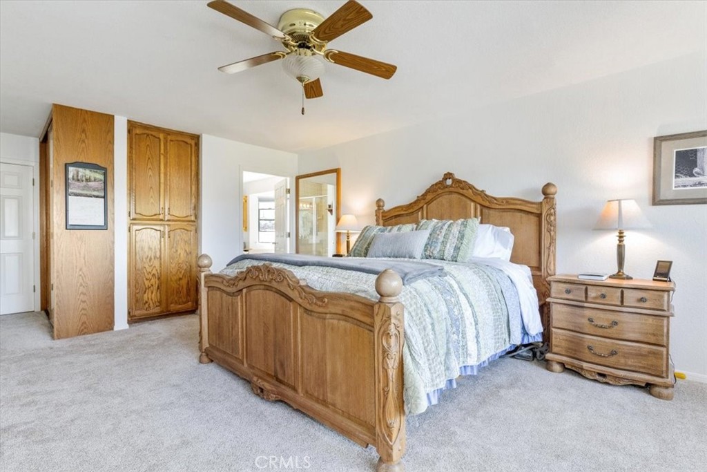 12355 Santa Ana Road Atascadero, CA 93422 - Photo 17 of 57 a bedroom with a bed and a chandelier