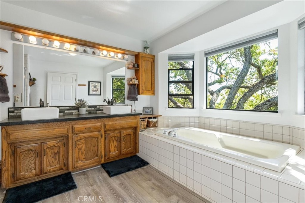 12355 Santa Ana Road Atascadero, CA 93422 - Photo 20 of 57 a spacious bathroom with a tub double sink window and mirror