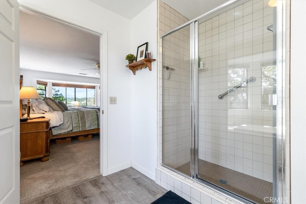 12355 Santa Ana Road Atascadero, CA 93422 - Photo 22 of 57 a bathroom with a glass door shower and a sink