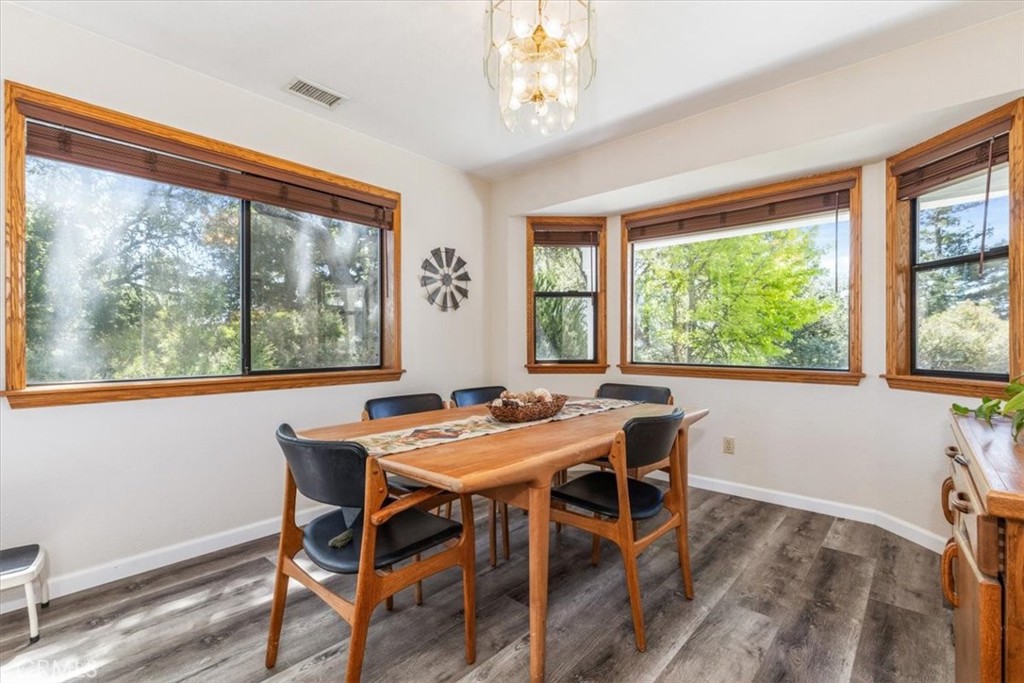12355 Santa Ana Road Atascadero, CA 93422 - Photo 29 of 57 a view of a dining room with furniture large windows and wooden floor
