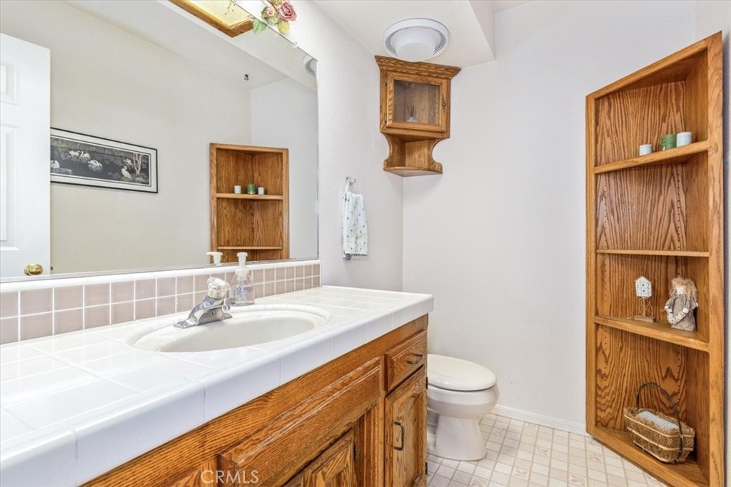 12355 Santa Ana Road Atascadero, CA 93422 - Photo 31 of 57 a bathroom with a sink a toilet and mirror