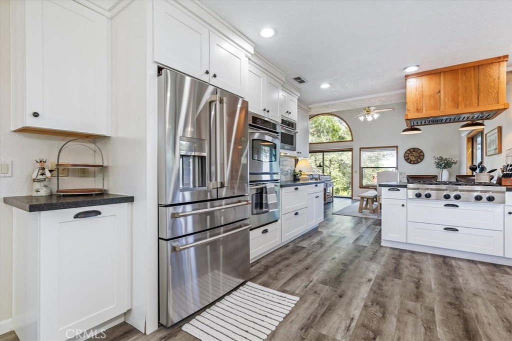 12355 Santa Ana Road Atascadero, CA 93422 - Photo 7 of 57 a kitchen with stainless steel appliances a refrigerator sink and cabinets