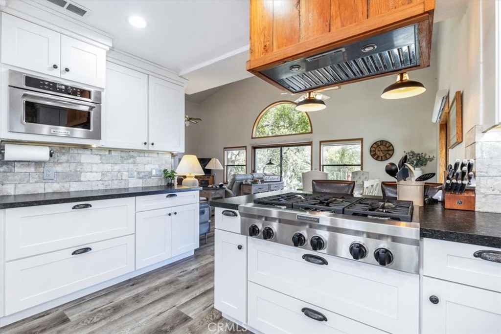 12355 Santa Ana Road Atascadero, CA 93422 - Photo 8 of 57 a kitchen with stainless steel appliances granite countertop a stove and cabinets
