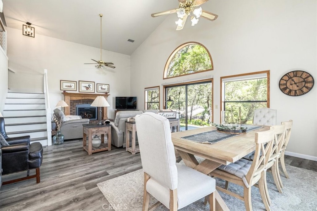 12355 Santa Ana Road Atascadero, CA 93422 - Photo 10 of 57 a dining room with wooden floor a chandelier a wooden table and chairs