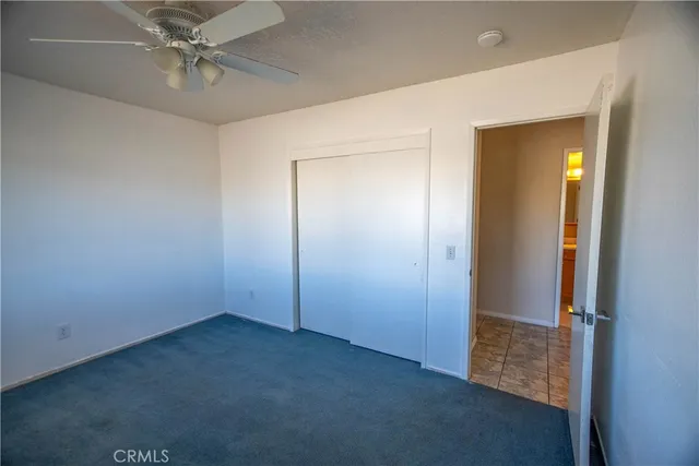 an empty room with windows and fireplace