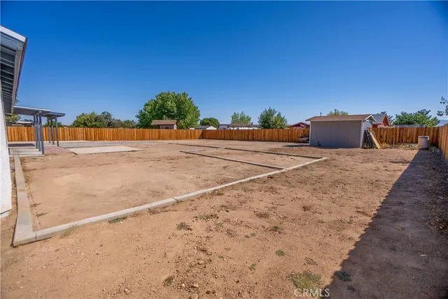 a view of a backyard with a wooden fence