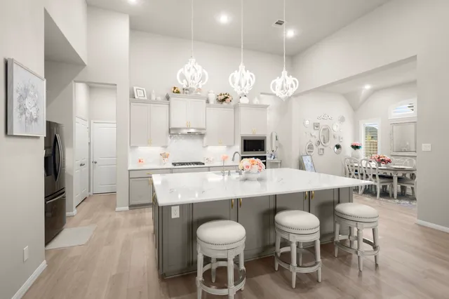 a large kitchen with a table and chairs