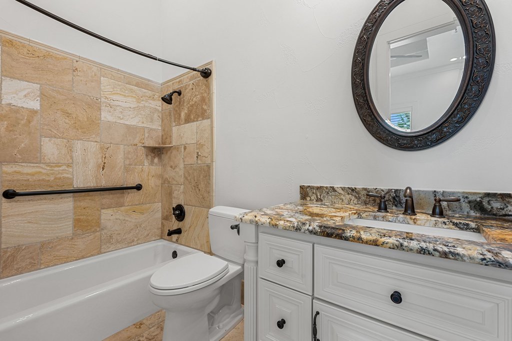 102 Long Point Cove Georgetown, TX 78628 - Photo 31 of 36 a bathroom with a sink a toilet and a mirror