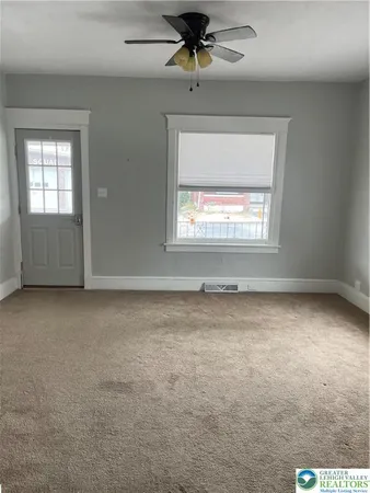 a view of an empty room with a window