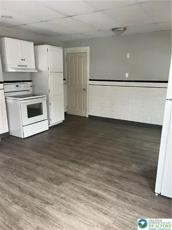 a view of a kitchen with wooden floor