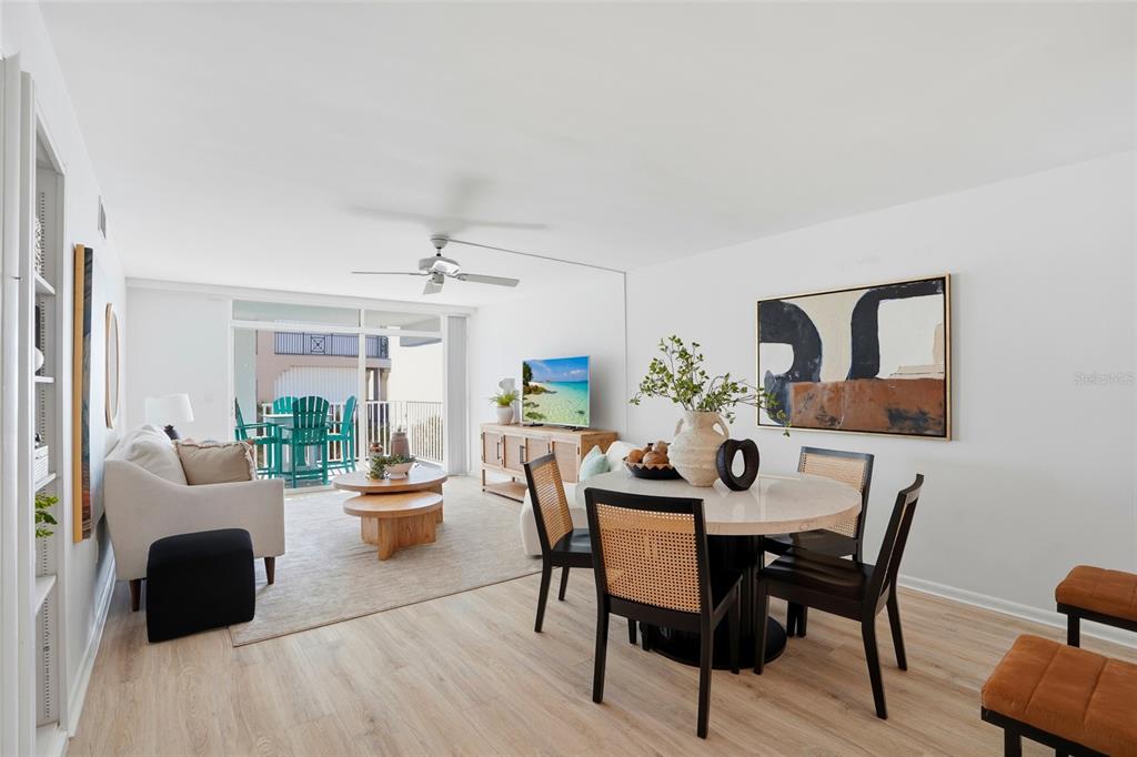 16308 Gulf Boulevard, Unit 303 Redington Beach, FL 33708 - Photo 11 of 42 a dining room with furniture potted plants and wooden floor