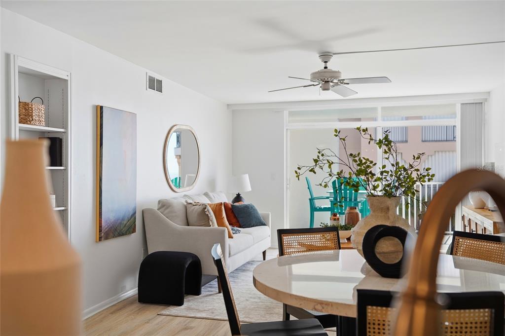 16308 Gulf Boulevard, Unit 303 Redington Beach, FL 33708 - Photo 12 of 42 a dining room with furniture potted plants and wooden floor