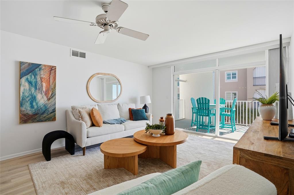 16308 Gulf Boulevard, Unit 303 Redington Beach, FL 33708 - Photo 15 of 42 a living room with fireplace furniture and a potted plant