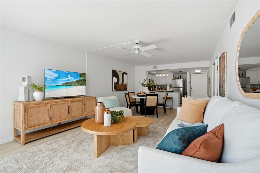 16308 Gulf Boulevard, Unit 303 Redington Beach, FL 33708 - Photo 16 of 42 a living room with furniture and a flat screen tv