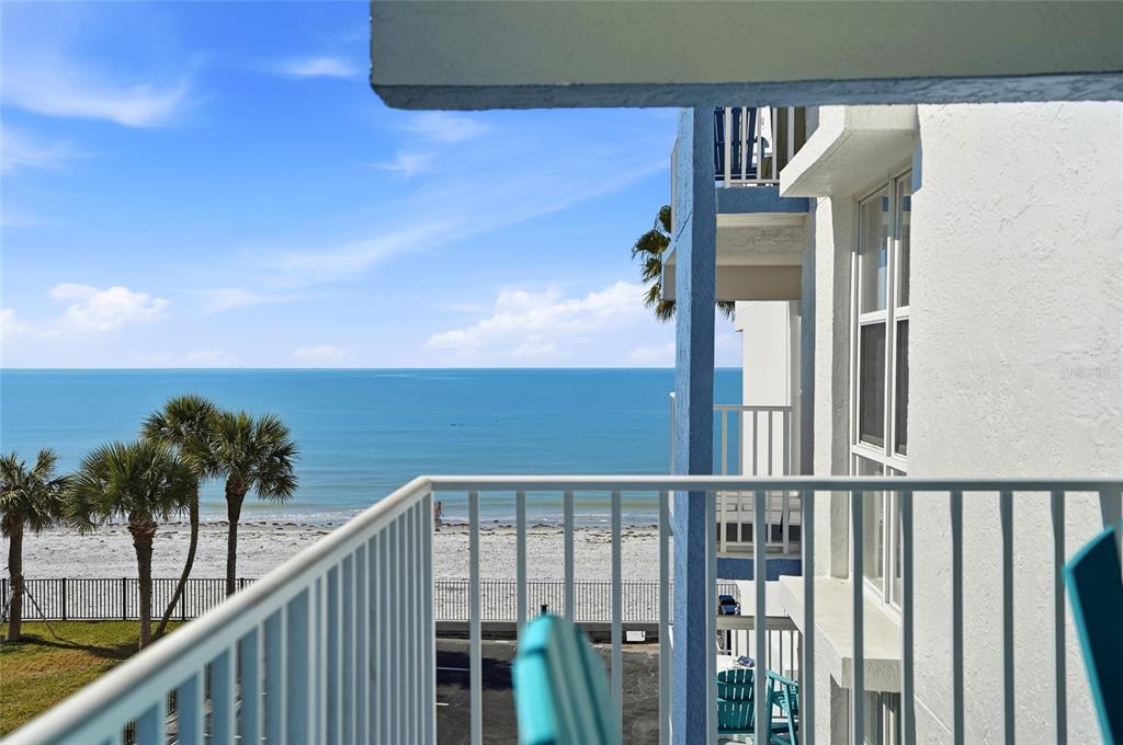 16308 Gulf Boulevard, Unit 303 Redington Beach, FL 33708 - Photo 17 of 42 a view of balcony with floor to ceiling windows and palm tree