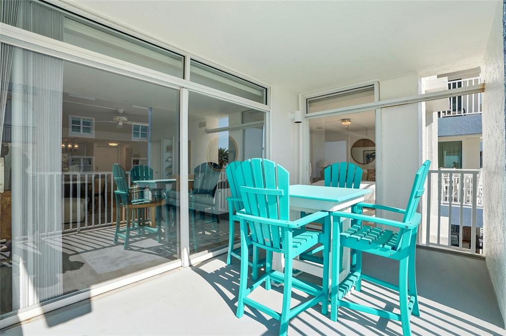 16308 Gulf Boulevard, Unit 303 Redington Beach, FL 33708 - Photo 20 of 42 a view of a dining room with furniture and a chandelier